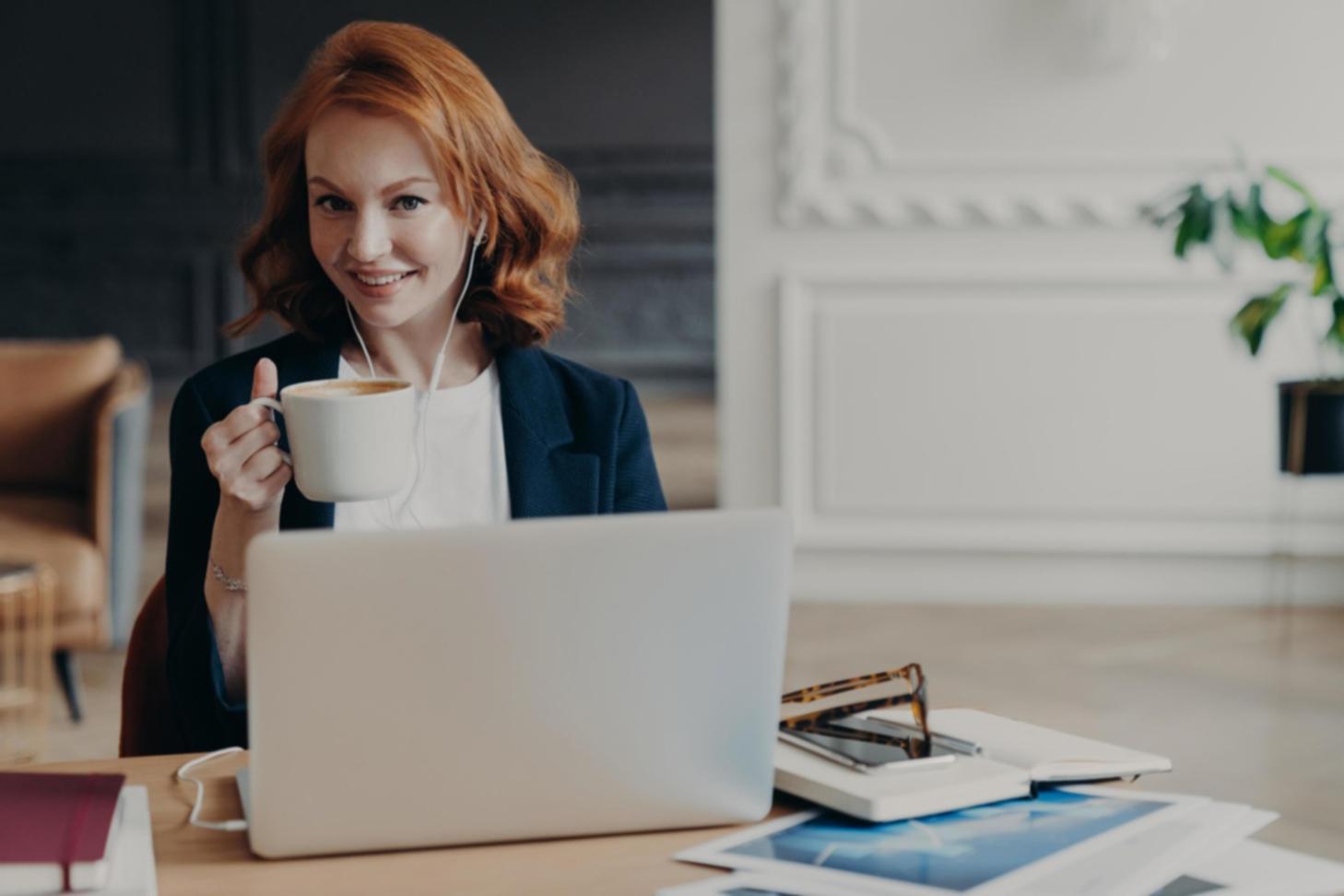 Person reviewing financial documents at organized home workspace